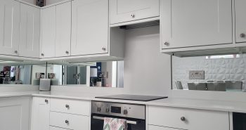 Mirrored glass splashback in a modern kitchen