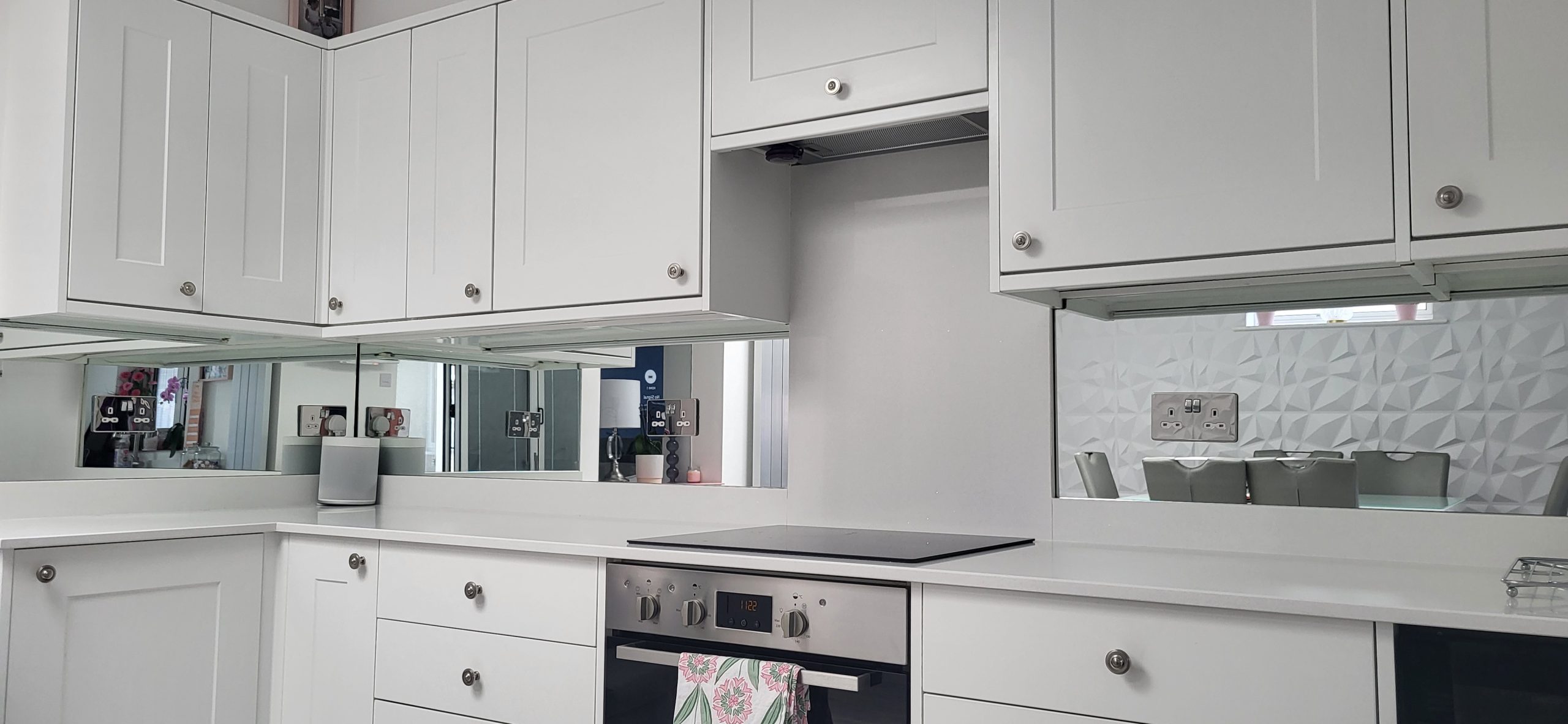 Mirrored glass splashback in a modern kitchen