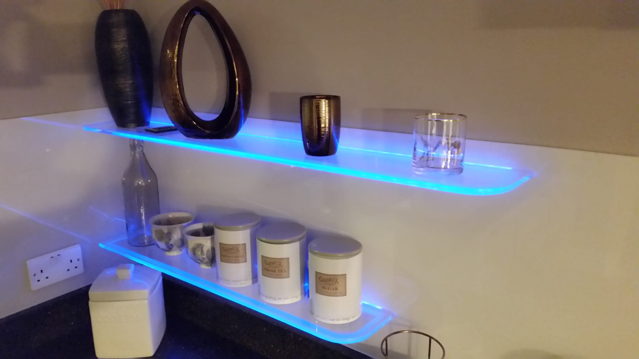 Kitchen shelves with blue light inserted into the structure